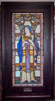 Stained Glass Window depicting the cardinal virtue Prudence, 1928.  Coloured glass of Prudence in a blue hooded robe holding a lamp.