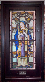 Stained Glass Window depicting the cardinal virtue Prudence, 1928.  Coloured glass of Prudence in a blue hooded robe holding a lamp.
