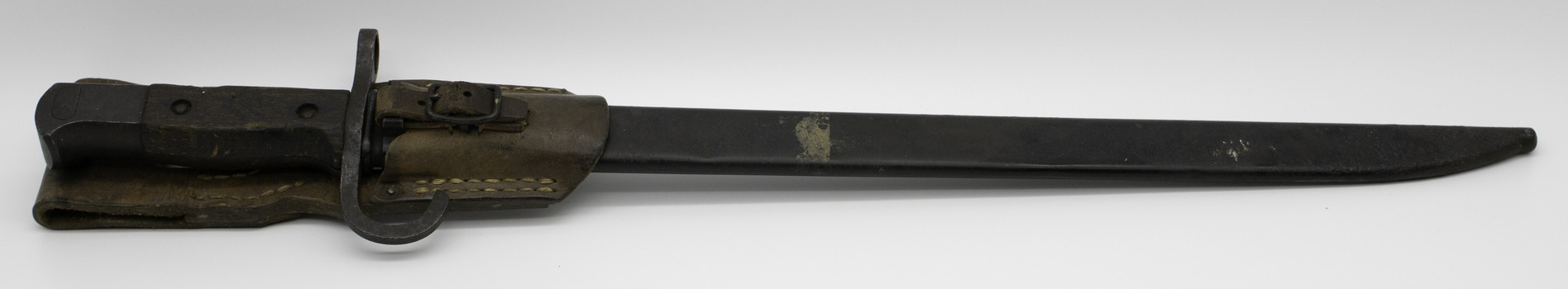 Metal knife in metal scabbard with leather belt holder on a white background
