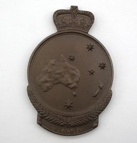 Bronze medal with southern cross stars and map of Australia, with crown crest on top and wreath underneath, engraving reads: W. J. Bentley. Lying flat on white background