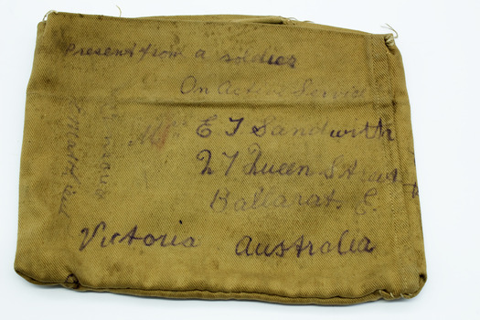 Khaki fabric, rectangular shape, with handwritten text in black ink, showing Ballarat East address, like an envelope.