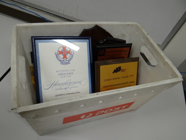 Box of plaques and flags