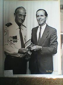 Photograph, medal presentation to ambulance officer