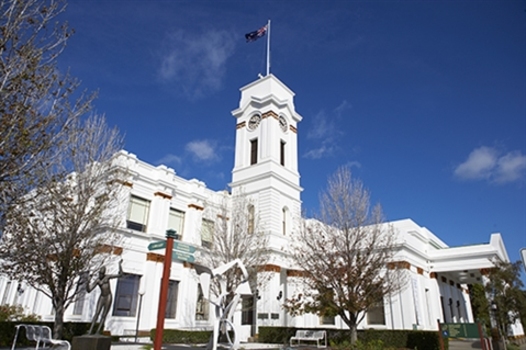 4 images of exterior townhall N, S, E, SE corner garden, white clock tower, portico, garden sculptures