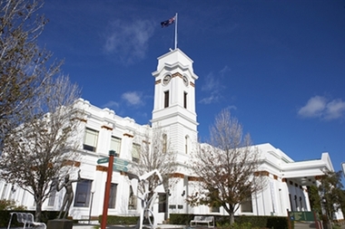 4 images of exterior townhall N, S, E, SE corner garden, white clock tower, portico, garden sculptures