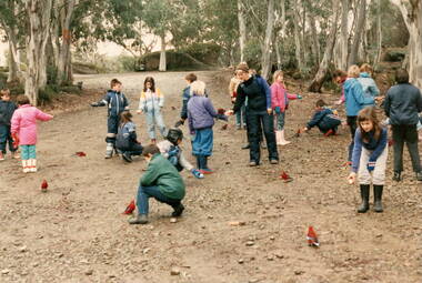 Children in the bush feeding some birds.