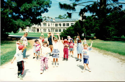 Children doing exercises in a park.