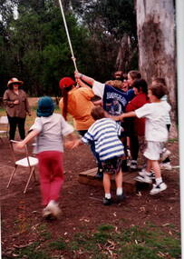 Children being shown basic rock climbing skills.