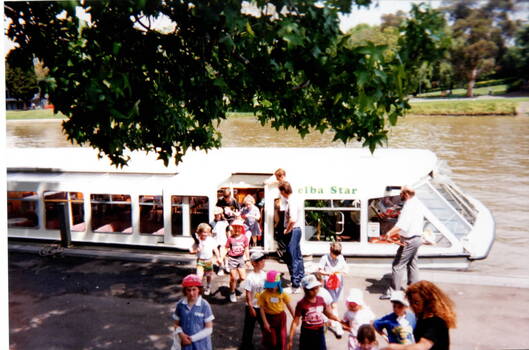 A group of children disembarking from a ferry.