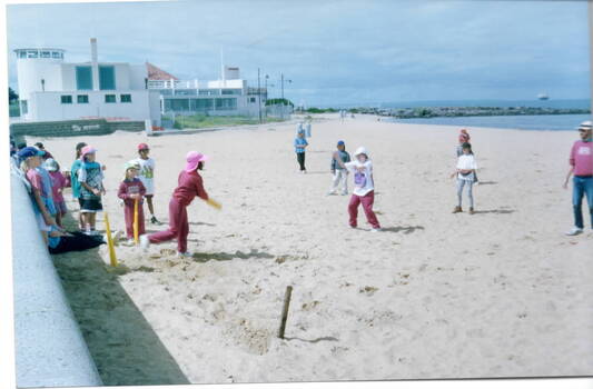 Children playing cricket on Williamstown Beach