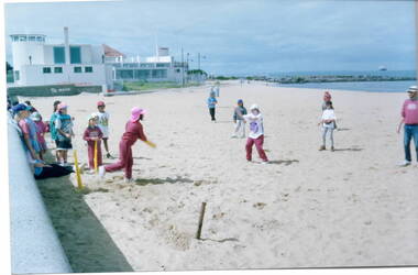 Children playing cricket on Williamstown Beach
