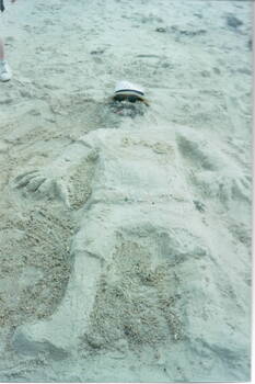 A sand sculpture of a man that the children did on Williamstown Beach.