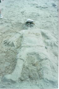 A sand sculpture of a man that the children did on Williamstown Beach.