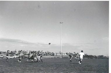 A football match being played on a sports ground.