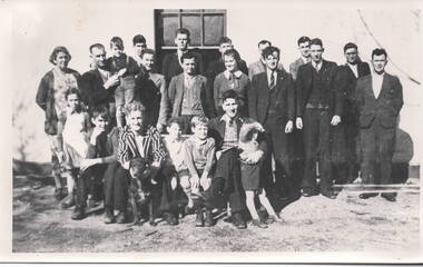 Twenty two people and a dog standing and sitting outside a hotel in Sunbury.