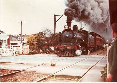 Vintage steam train leaving Mitcham station