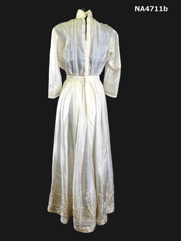 Cream silk wedding dress. High neck with a stand up shaped collar in the Queen Mary style.