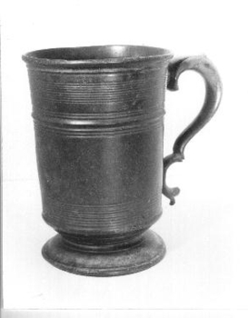 Large metal tankard with curved handle made of Brittania metal