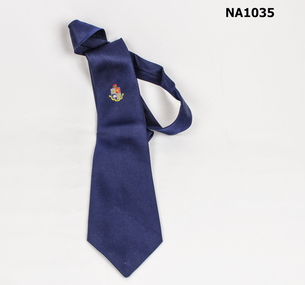 Navy blue tie with motif of City of Nunawading Coat of Arms in centre
