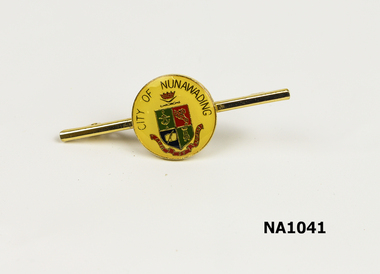 Small circular yellow badge on gold bar. 'City Of Nunawading' and coat of arms on badge.