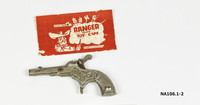 Toy silver metal gun with movable hammer for caps. 