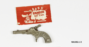 Toy silver metal gun with movable hammer for caps. 