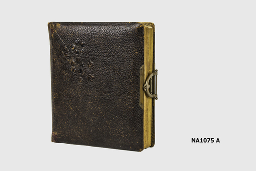 Leather covered photo album with metal clasp containing photographs of  the family of Arthur Howden. 