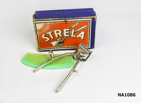 Box containing metal hair clipper and two plastic combs. 