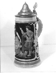 Traditional German beer stein with pewter lid worked by lever on handle.