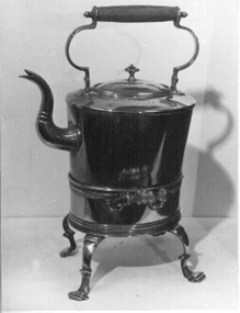 Large brass kettle on four legged stand. 