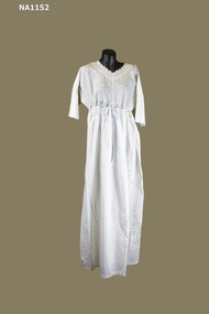Long white cotton nightdress embroidered in white at neckline and sleeves.