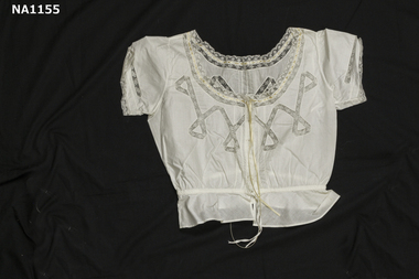 Fine white cotton camisole with lace inserts and cream ribbon in eyelet lace at neck. 