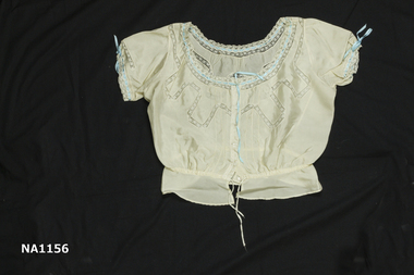 Cream silk camisole with lace inserts. Blue ribbon in eyelet lace at neck.