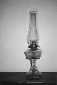  Tall, slender glass kerosene lamp with wick in place.