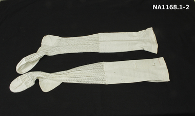 A pair of machine knitted white lace stockings of the Victorian era between 1850 -1880. 