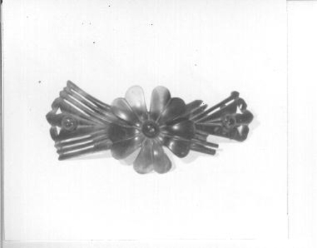  Ornamental tortoiseshell comb with large flower in centre.