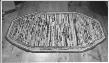 Large multi-coloured rag rug.