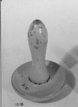 Wooden instrument with rounded end and wooden handle