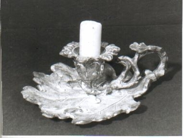 Silver candle holder in shape of leaf. 