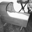 Wooden cradle with wooden canopy. 