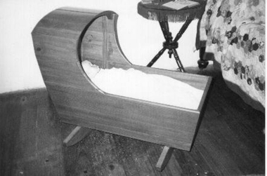 Wooden cradle with wooden canopy. 