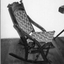 Wooden rocking chair with wooden carved back. 