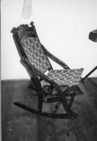 Wooden rocking chair with wooden carved back. 