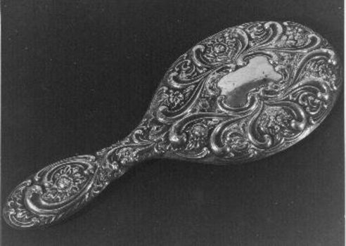 Ornate silver backed hand mirror. 