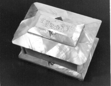 Physical description  Rectangular box with lid covered in mother of pearl.