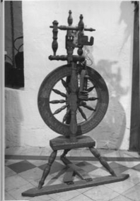 Wooden spinning wheel on stand
