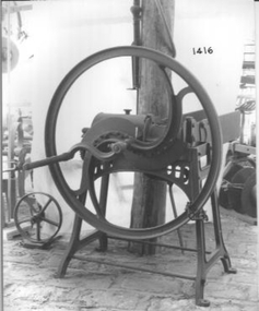 Large caste iron wheel on which two knife cutters are fitted - hand rotated 