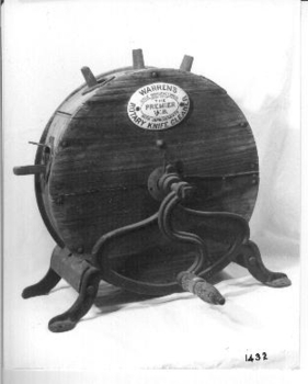  Wooden round container on metal legs with a metal handle to turn it with. 