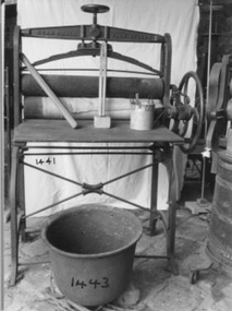 Solid iron frame with three wooden rollers. 