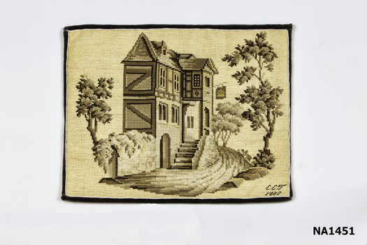 Tapestry of canvas needlework in shades of creams into brown. Picture of double story house and trees.